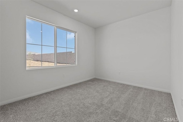 empty room with recessed lighting, carpet flooring, and baseboards