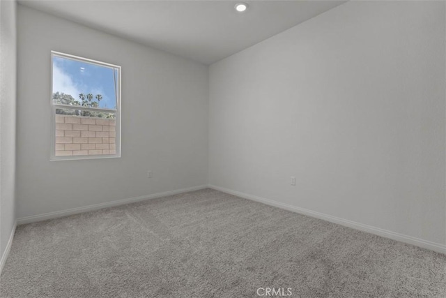 spare room featuring baseboards, carpet, and recessed lighting