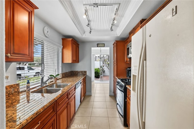 18815 Thornwood Cir Unit Ci32, Huntington Beach, CA 92646 - kitchen featuring rail lighting, stone countertops, a sink, stainless steel appliances, and a raised ceiling