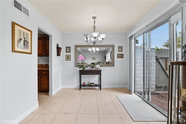 18815 Thornwood Cir Unit Ci32, Huntington Beach, CA 92646 - interior space with an inviting chandelier, light tile patterned flooring, visible vents, and baseboards