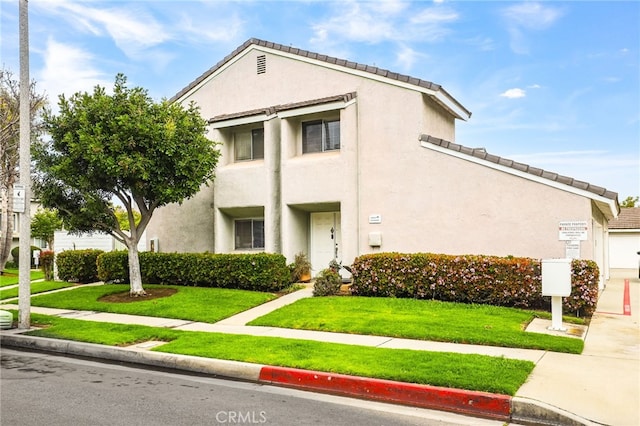 18815 Thornwood Cir Unit Ci32, Huntington Beach, CA 92646 - view of front of property with stucco siding and a front lawn