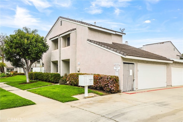 18815 Thornwood Cir Unit Ci32, Huntington Beach, CA 92646 - view of side of property with mail area, an attached garage, concrete driveway, and stucco siding