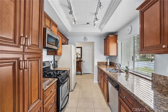 18815 Thornwood Cir Unit Ci32, Huntington Beach, CA 92646 - kitchen with stainless steel appliances, track lighting, a raised ceiling, a sink, and dark stone counters