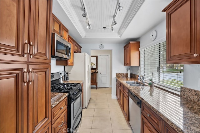 18815 Thornwood Cir Unit Ci32, Huntington Beach, CA 92646 - kitchen featuring track lighting, stainless steel appliances, a raised ceiling, brown cabinets, and crown molding