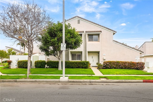 18815 Thornwood Cir Unit Ci32, Huntington Beach, CA 92646 - neoclassical / greek revival house featuring a tile roof, a front lawn, and stucco siding