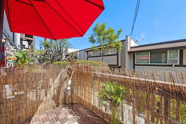 view of side of home with cooling unit and a fenced backyard