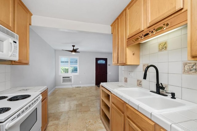 kitchen featuring white appliances, tile countertops, a sink, and tasteful backsplash
