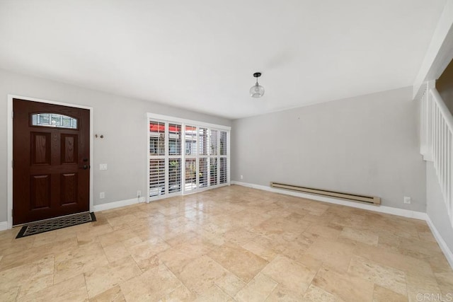 foyer featuring a healthy amount of sunlight, baseboards, a baseboard radiator, and stone finish floor