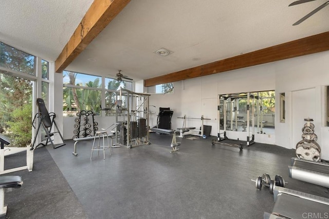 workout area with ceiling fan and a textured ceiling