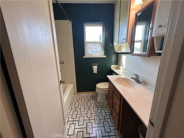 bathroom with shower / bath combination, baseboards, toilet, and vanity