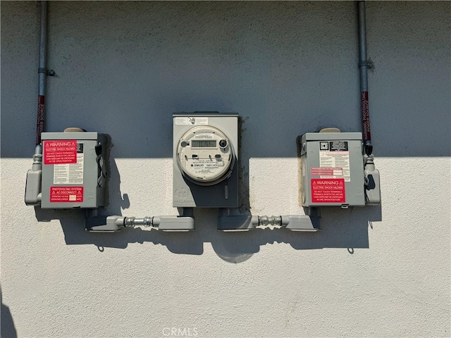 exterior details with stucco siding and electric meter