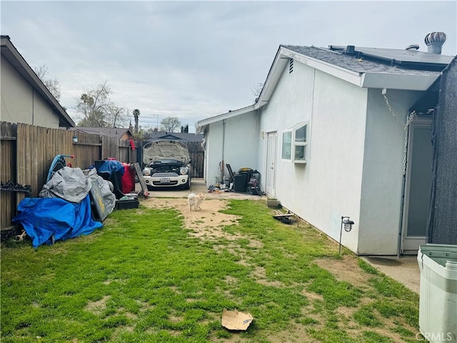 exterior space featuring a yard and fence