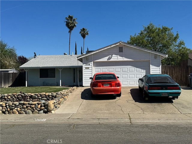 single story home with a garage, driveway, a front yard, and fence