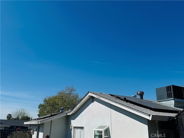 exterior space with cooling unit and stucco siding