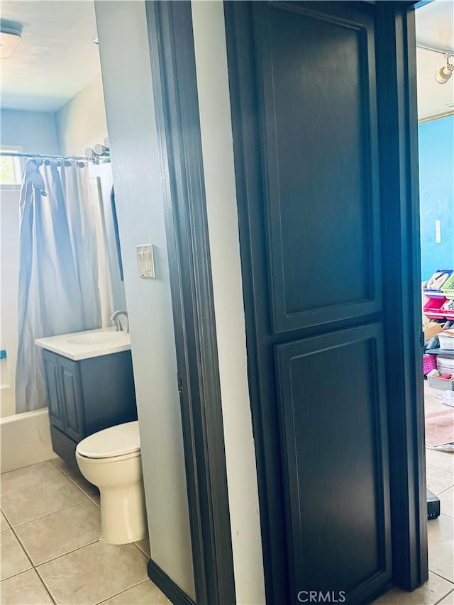 full bathroom with tile patterned floors, vanity, and toilet