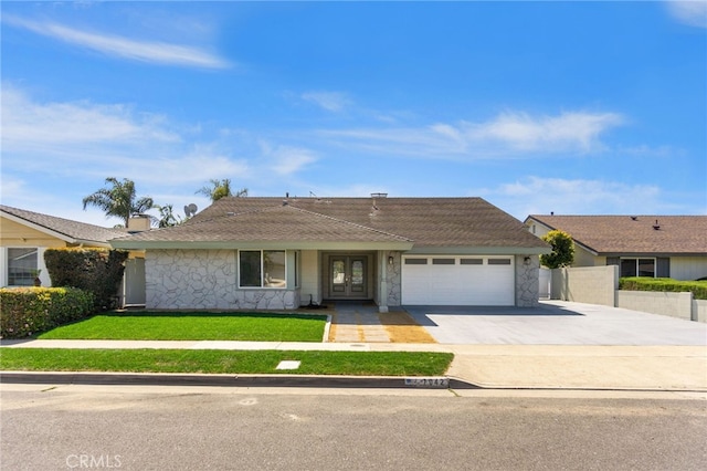 7042 Stonewood Dr, Huntington Beach, CA 92647 - ranch-style home with concrete driveway, an attached garage, stone siding, french doors, and a front yard