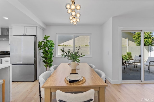 7042 Stonewood Dr, Huntington Beach, CA 92647 - dining area featuring an inviting chandelier, light wood-style flooring, and baseboards