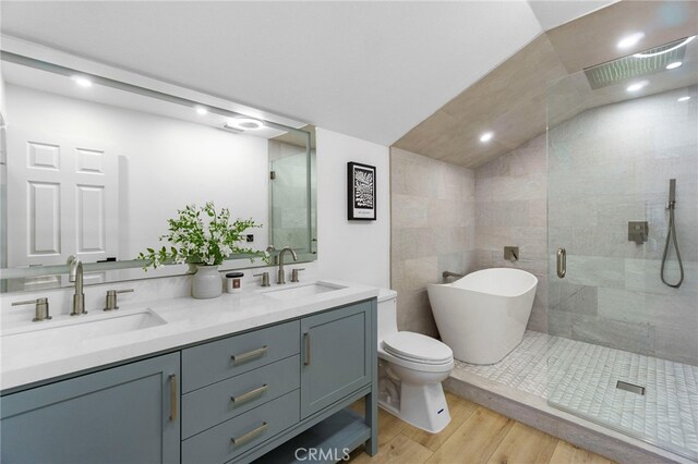 7042 Stonewood Dr, Huntington Beach, CA 92647 - bathroom featuring wood finished floors, a sink, a freestanding tub, and a shower stall