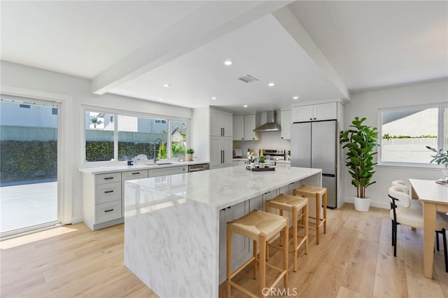 7042 Stonewood Dr, Huntington Beach, CA 92647 - kitchen featuring a sink, wall chimney exhaust hood, a center island, stainless steel appliances, and beamed ceiling