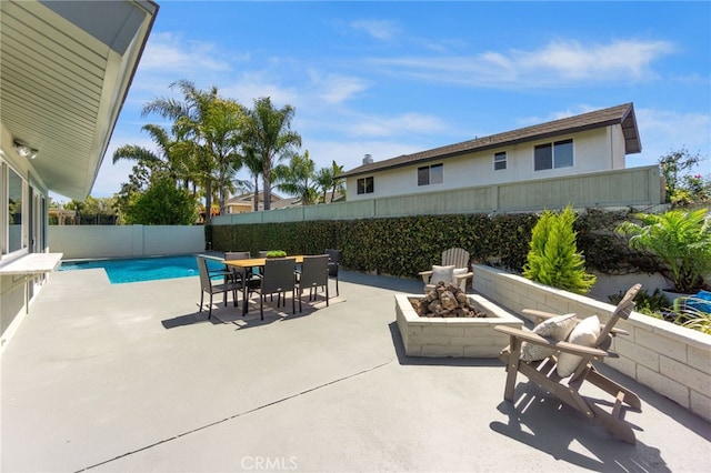 7042 Stonewood Dr, Huntington Beach, CA 92647 - view of patio featuring a fenced backyard, a fire pit, outdoor dining space, and a fenced in pool