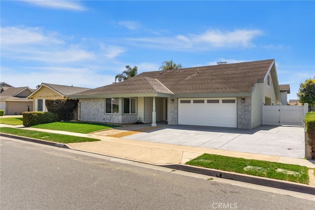 7042 Stonewood Dr, Huntington Beach, CA 92647 - ranch-style home featuring stone siding, driveway, a front yard, a gate, and a garage