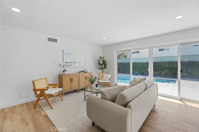 7042 Stonewood Dr, Huntington Beach, CA 92647 - living room featuring baseboards, visible vents, light wood-style flooring, and recessed lighting