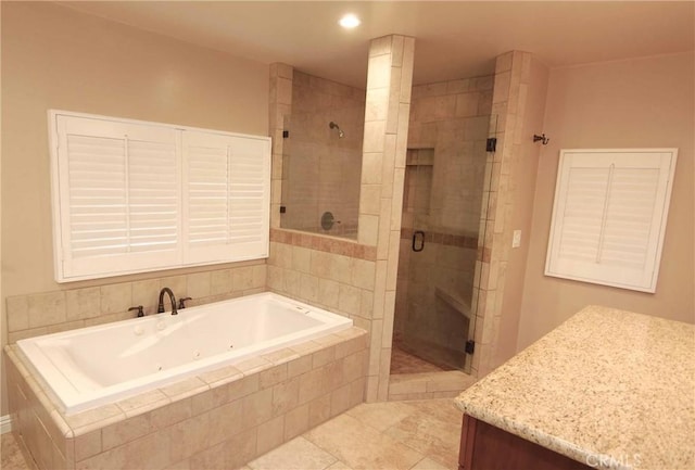 bathroom with a stall shower, a tub with jets, and tile patterned flooring