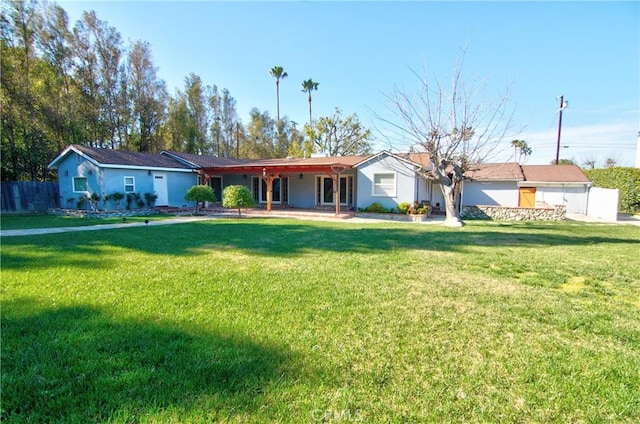 ranch-style house featuring stucco siding and a front lawn