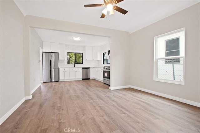 2619 Alice St, Los Angeles, CA 90065 - unfurnished living room with baseboards, light wood-style floors, ceiling fan, and a sink