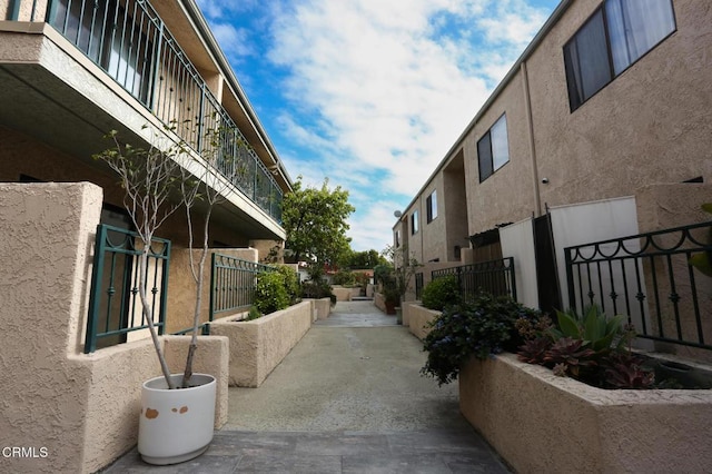 view of home's community featuring fence