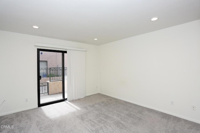 carpeted empty room with baseboards and recessed lighting