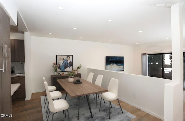 dining space with recessed lighting, baseboards, and wood finished floors