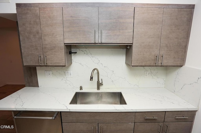 kitchen with a sink, decorative backsplash, stainless steel dishwasher, and dark brown cabinets