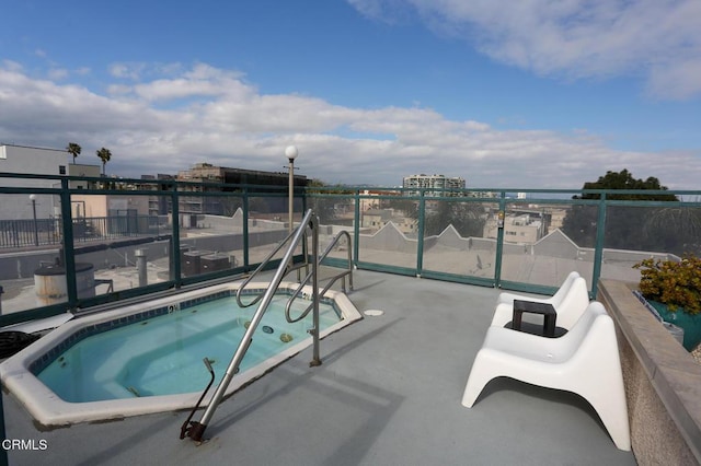 view of swimming pool with a hot tub