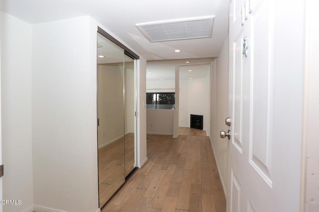 hall featuring recessed lighting, visible vents, and light wood-style flooring
