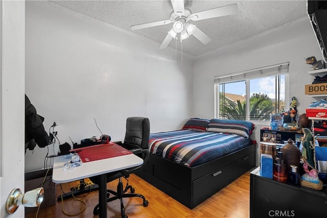 178 E 49th St, Los Angeles, CA 90011 - bedroom with wood finished floors, ceiling fan, and a textured ceiling