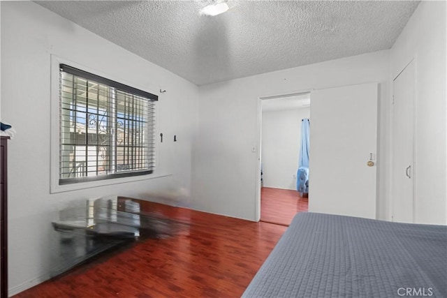 178 E 49th St, Los Angeles, CA 90011 - bedroom featuring wood finished floors and a textured ceiling