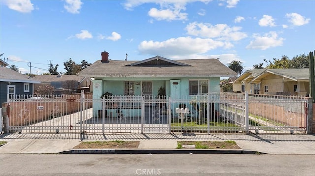 178 E 49th St, Los Angeles, CA 90011 - bungalow-style home featuring a chimney, a fenced front yard, a gate, and a porch