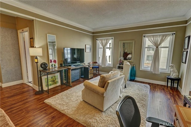 living room with baseboards, ornamental molding, a textured ceiling, and wood finished floors