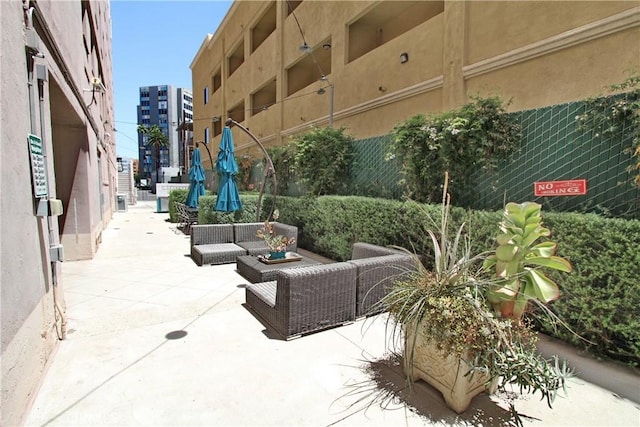 view of community with outdoor lounge area and a patio