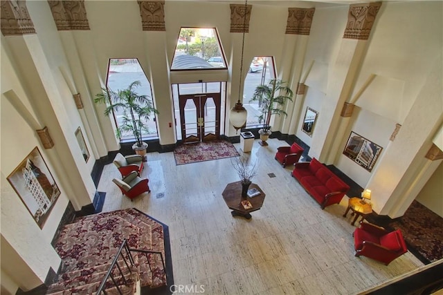 foyer entrance with a high ceiling and baseboards