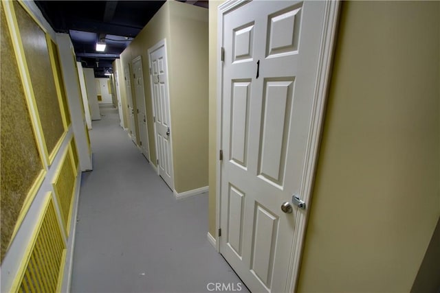 hallway featuring baseboards and visible vents