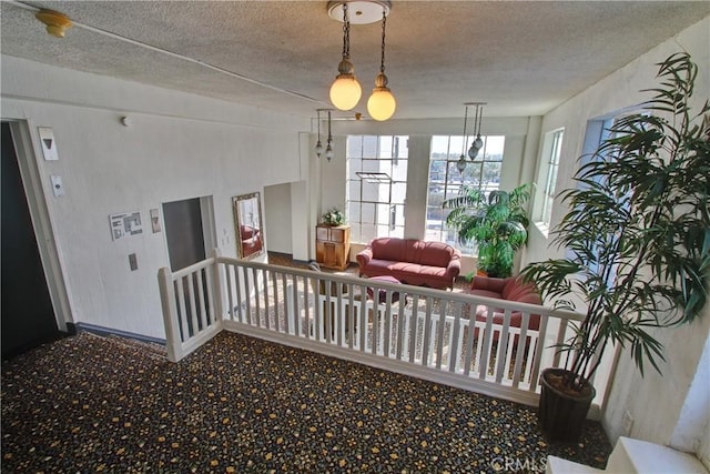 interior space featuring a textured ceiling and carpet