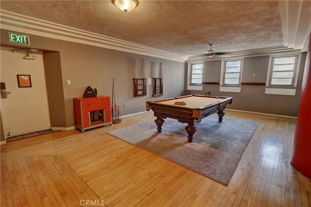 playroom featuring hardwood / wood-style floors, a textured ceiling, baseboards, ceiling fan, and billiards