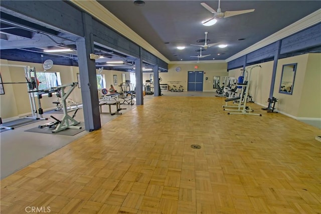 gym featuring baseboards, crown molding, and ceiling fan