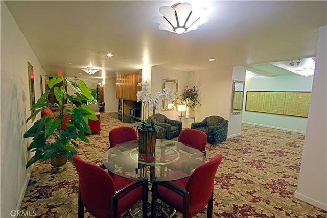 dining area with baseboards and carpet floors