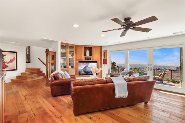 living area featuring stairs, visible vents, recessed lighting, light wood finished floors, and a ceiling fan