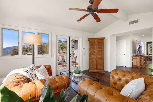 living area featuring wood finished floors, visible vents, a ceiling fan, baseboards, and vaulted ceiling with beams