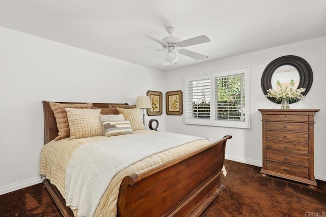 bedroom featuring baseboards, a ceiling fan, and dark carpet