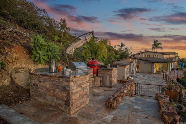 view of front facade with a patio and area for grilling